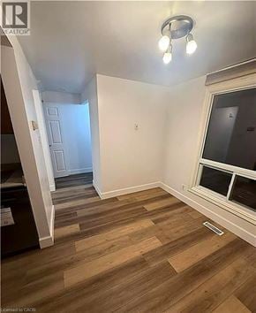 Cambridge townhouse for rent - A room with wooden flooring and a window.