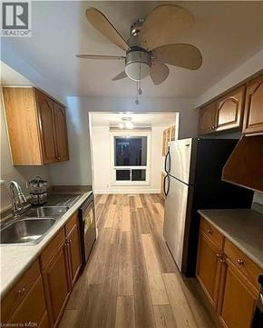 Cambridge townhouse for rent - A kitchen with wooden cabinets and a black refrigerator.