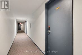 Ottawa condo for rent - A hallway with a closed door on the right and a door at the end of the hallway.