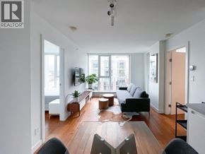 Vancouver apartment for rent - A living room with a couch, a chair, a coffee table, and a television.