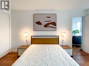 Vancouver apartment for rent - A bedroom with a bed, nightstands, and a painting on the wall.