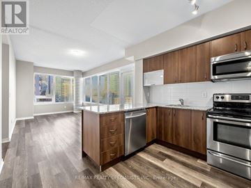 Toronto (Niagara) condo for rent - A kitchen with wooden cabinets and stainless steel appliances.