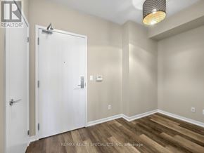 Toronto (Niagara) condo for rent - A room with a white door and a light brown floor.