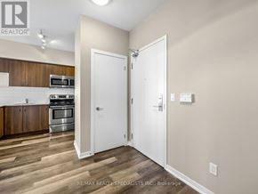 Toronto (Niagara) condo for rent - A kitchen with a microwave, oven, and cabinets.