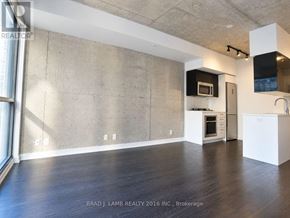 Toronto (Waterfront Communities) condo for rent - A spacious kitchen with white cabinets and a microwave above the oven.