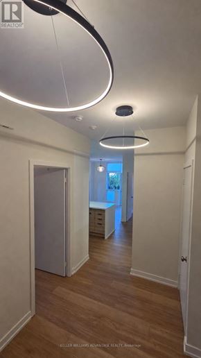 Toronto (Regent Park) condo for rent - A hallway with a light on the ceiling and a door on the left.