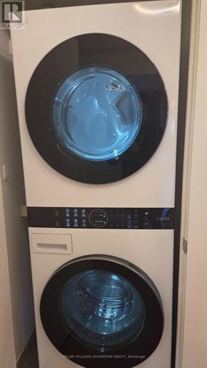 Toronto (Regent Park) condo for rent - A washing machine with a blue light on the front.
