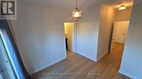 Toronto (Regent Park) condo for rent - A room with a wooden floor and white walls, with a light hanging from the ceiling.