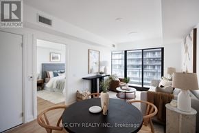 Toronto (Thorncliffe Park) condo for rent - A living room with a black table and a brown chair.