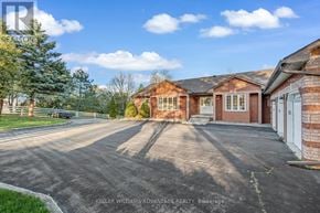 Milton apartment for rent - A large brick house with a driveway in front of it.