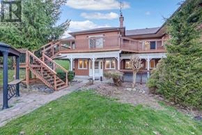 Milton apartment for rent - A house with a red brick chimney and a deck with a railing.
