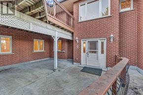 Milton apartment for rent - A red brick house with a balcony and a door.