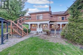 Milton apartment for rent - A house with a red brick chimney and a deck with a railing.