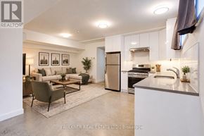 Ottawa apartment for rent - A modern kitchen and living room with a dining table and chairs.