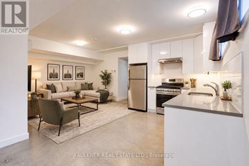 Ottawa apartment for rent - A modern kitchen and living room with a dining table and chairs.