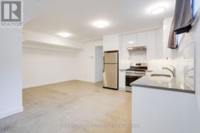 Ottawa apartment for rent - A kitchen area with a refrigerator, oven, and sink.