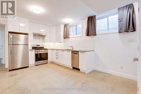 Ottawa apartment for rent - A kitchen with white cabinets and a stainless steel refrigerator.