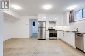 Ottawa apartment for rent - A kitchen with white cabinets and stainless steel appliances.