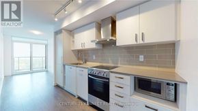 Toronto (Mount Pleasant West) condo for rent - A kitchen with white cabinets and a tiled backsplash.