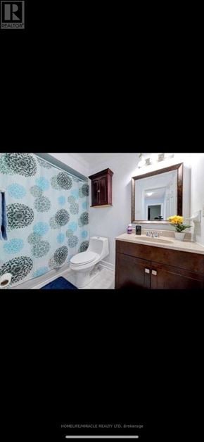 Brampton (Sandringham-Wellington) townhouse for rent - A bathroom with a toilet, sink, and mirror.