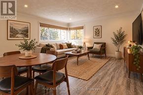 Ottawa multi-family for rent - A well-lit living room with a dining table and chairs.