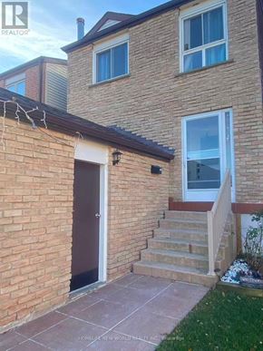 Vaughan (Glen Shields) apartment for rent - A brick house with a brown door and a window.