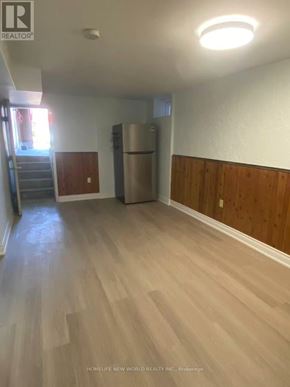 Vaughan (Glen Shields) apartment for rent - A room with wooden floors and a refrigerator in the corner.