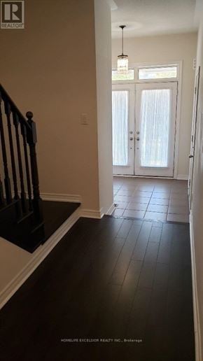 Markham (Greensborough) townhouse for rent - A hallway with a wooden floor and a chandelier.