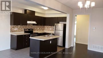 Markham (Greensborough) townhouse for rent - A modern kitchen with a stone backsplash and dark cabinets.