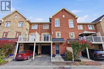 Pickering (Town Centre) townhouse for rent - A red brick house with a balcony and a car parked in front.