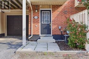 Pickering (Town Centre) townhouse for rent - A brick house with a black door and a glass window above it.
