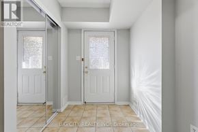 Pickering (Town Centre) townhouse for rent - A white hallway with two doors and a brokerage sign.