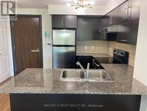 Markham (Commerce Valley) condo for rent - A kitchen with a sink and a refrigerator.