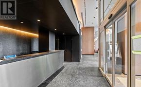 Pickering (Bay Ridges) condo for rent - A modern office lobby with a reception desk and glass walls.