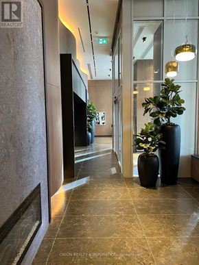 Pickering (Bay Ridges) condo for rent - A hallway with a plant in a black vase on the right.