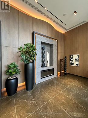 Pickering (Bay Ridges) condo for rent - A living room with a fireplace and two vases.