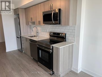 Pickering (Bay Ridges) condo for rent - A kitchen with a stove top oven and microwave above it.