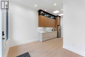 Toronto (Bendale) apartment for rent - A kitchen with white walls and wooden cabinets.