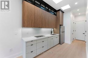 Toronto (Bendale) apartment for rent - A kitchen with wooden cabinets and white countertops.
