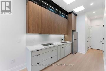 Toronto (Bendale) apartment for rent - A kitchen with wooden cabinets and white countertops.