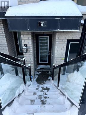 Toronto (Malvern) townhouse for rent - A snow-covered front porch with a black awning and a sign that says "UNI".