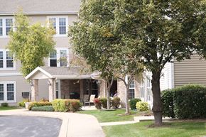 Cedarburg apartment for rent - a house with a driveway and trees in front of it