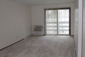 Saukville apartment for rent - an empty living room with a window and a heater on the floor