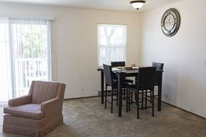 Cedarburg apartment for rent - a dining room with a table and chairs and a clock on the wall