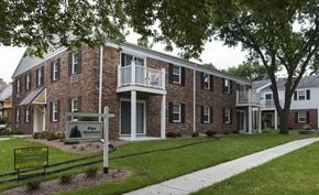 Cedarburg apartment for rent - a brick building with a sign in front of it