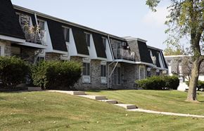 Grafton apartment for rent - a building with a lawn and trees in front of it