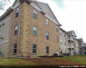 Cedarburg apartment for rent - a brick apartment building with a yard in front of it