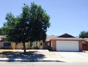 Lanacaster house for rent - A tree in front of a house with a garage door.
