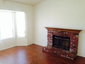 Lanacaster house for rent - A room with a fireplace and wood flooring.