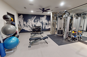 Denver apartment for rent - A gym with a variety of equipment including weights and a bench.